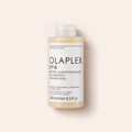 Šampon Olaplex No.4 Bond Maintenance 250 ml na béžovém pozadí – MrRizz